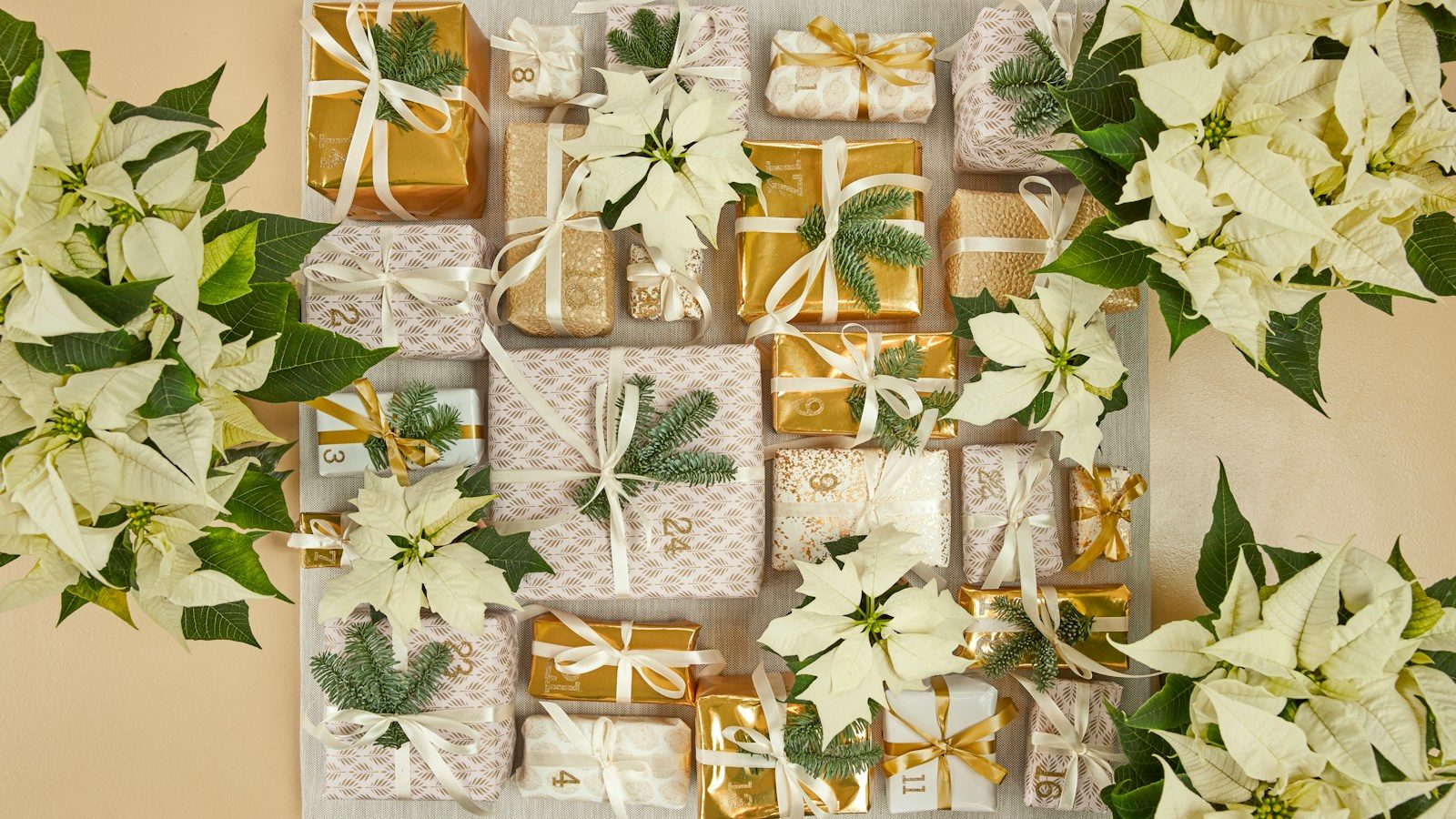A table topped with lots of white flowers and wrapped presents